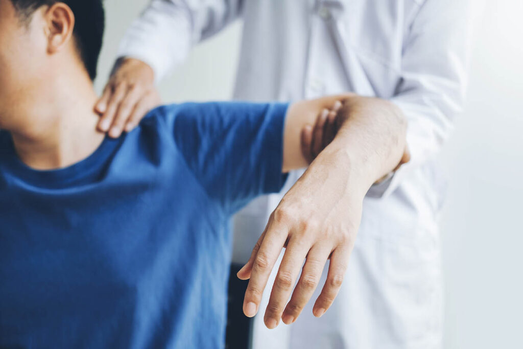 Doctor consulting with patient about shoulder muscle pain problems