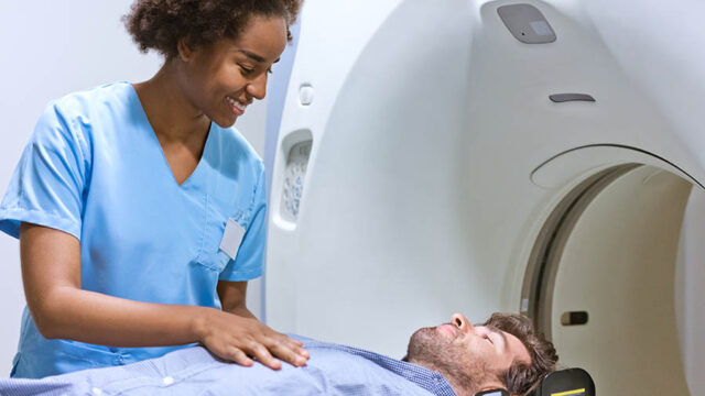 radiologist preparing man for MRI scan